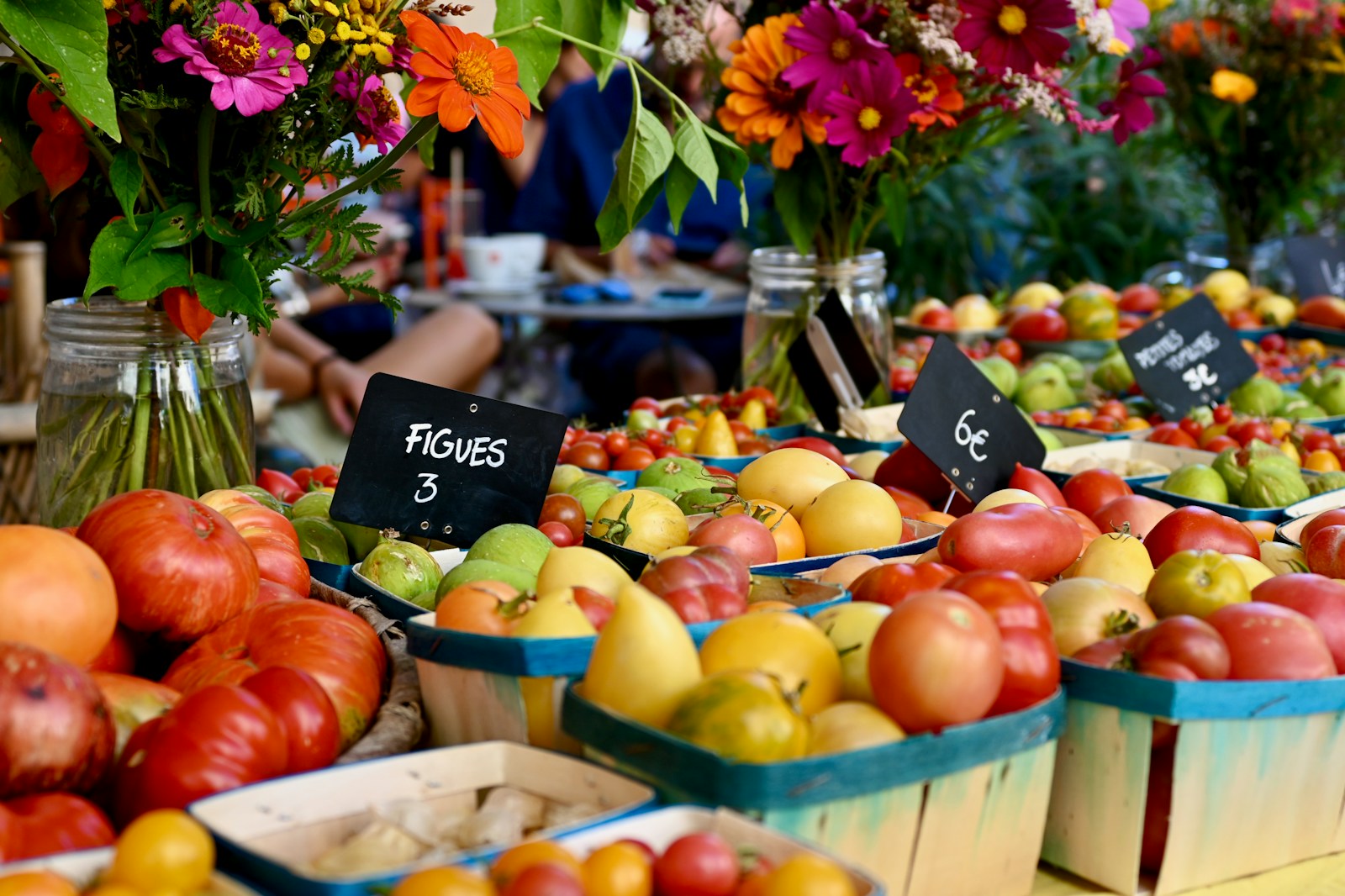 Photo by Markus Ilg a bunch of baskets filled with lots of fruit